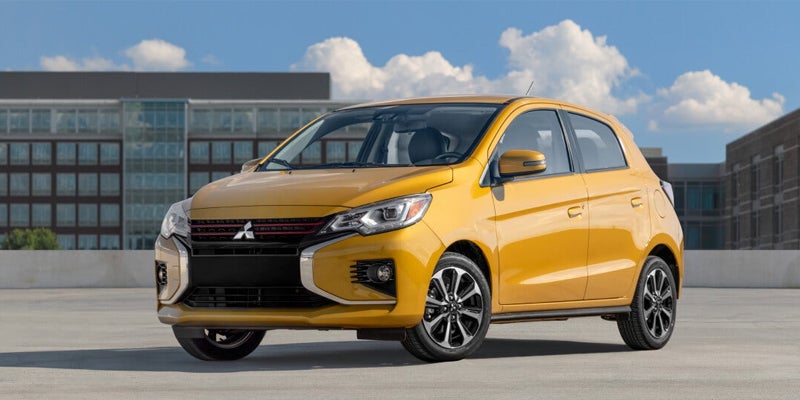 A Yellow Mirage Car parked front of building