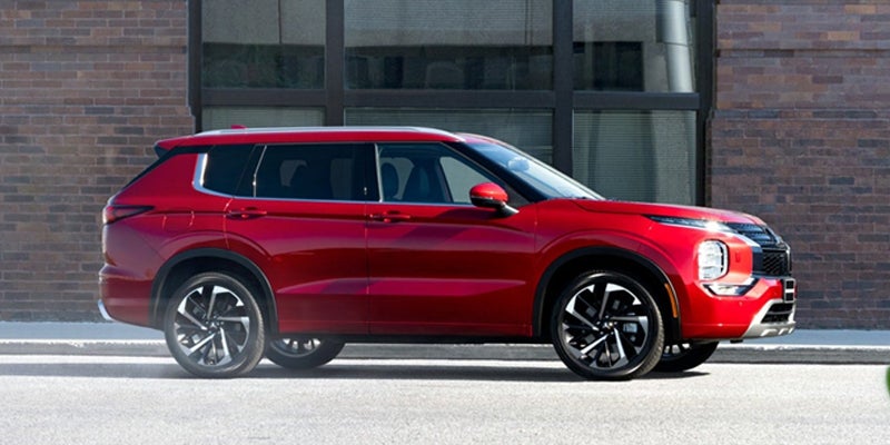 A red Outlander parked side of city road