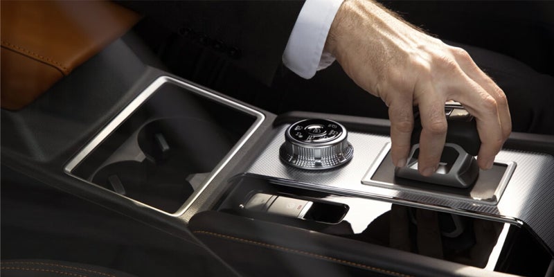 A person in Outlander driving a car and he's hand on gear of Outlander